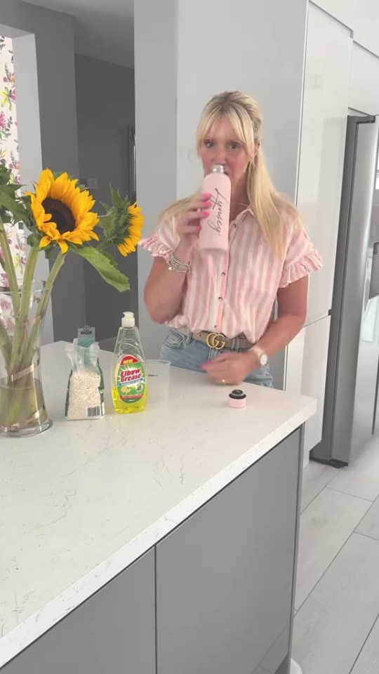 Woman demonstrating how to clean a water bottle.