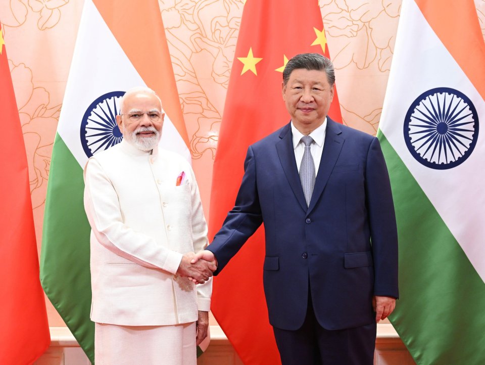 Xi Jinping and Narendra Modi shaking hands.