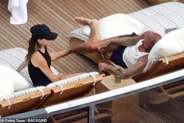 The loved-up couple were seen chatting as they both relaxed on sunbeds in the baking Italian sunshine on Wednesday
