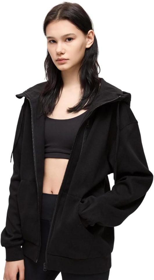 Woman wearing a black zip-up hoodie.