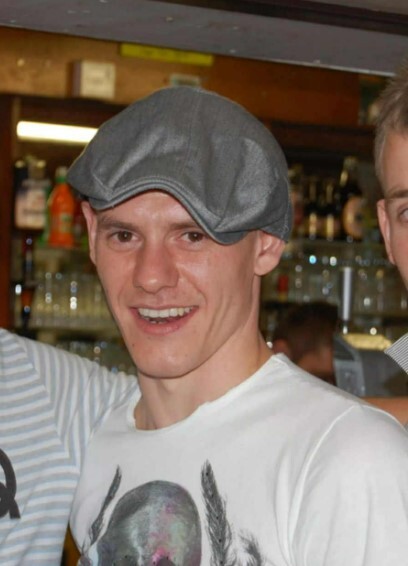 Photo of Matthew Jones wearing a newsboy cap.