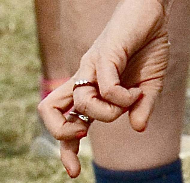 She made no attempt to hide the gold band featuring three sparkling diamonds (above) when she appeared at the Big Feastival in the Cotswolds last Sunday