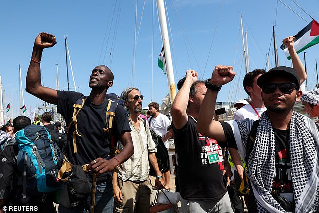 People gesture on the day of the departure of the Global Sumud Flotilla, a humanitarian expedition to Gaza, at the port of Barcelona, Spain August 31, 2025