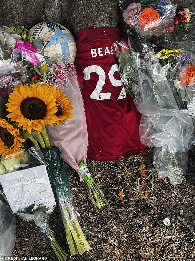 A football shirt with the number 29 and 'Bear' written on the back was among the heartfelt tributes left by a tree today