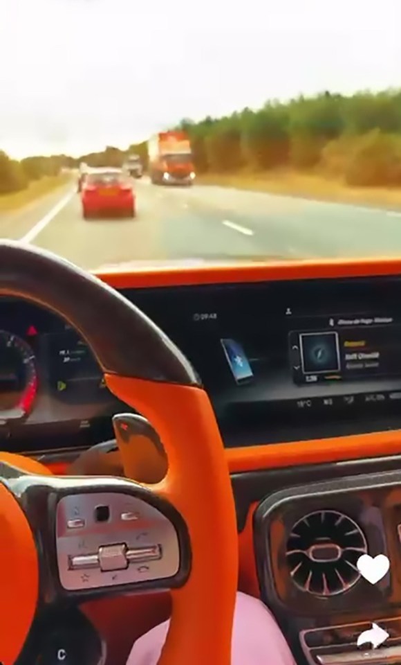 Screenshot of a Snapchat video showing a person driving and filming themselves while driving a Lamborghini.