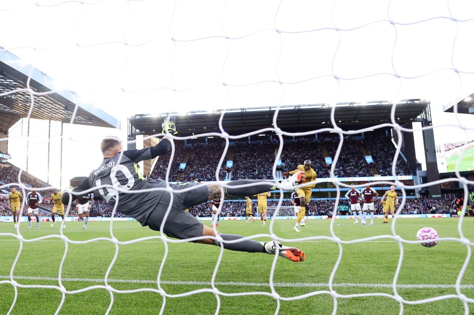 Aston Villa goalkeeper Marco Bizot misses a save during a Premier League match.