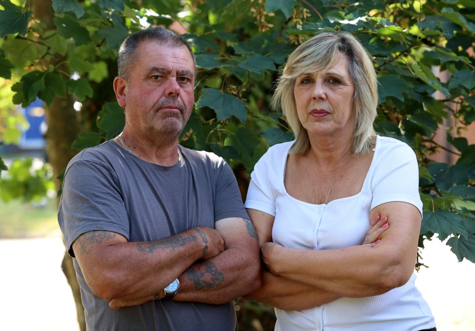 Portrait of a man and woman standing with arms crossed.