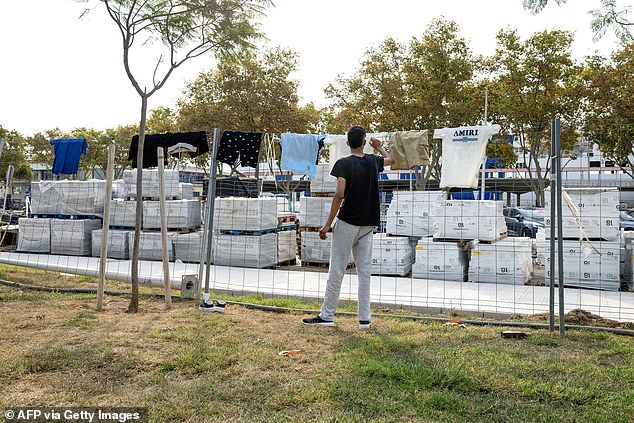 There has been a surge in the number of migrants arriving on the shores of the Balearic Islands (Pictured: A migrant hanging his clothes in a park in Majorca on August 24, 2025)