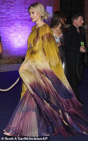 Paris ensured all eyes were on her in the flowing ombre look which also boasted a cut out to display her toned and tattooed waist