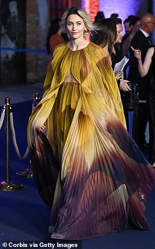 Paris ensured all eyes were on her in the flowing ombre look which also boasted a cut out to display her toned and tattooed waist