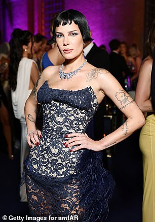 The star teased a glimpse of her lingerie toned and tattooed physique as well as her skimpy lingerie as she oozed confidence and posed with her hands on her hips