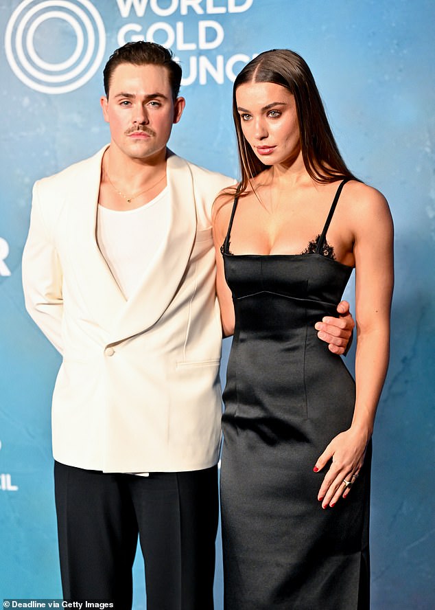 While he was suited and booted she wore a chic satin dress