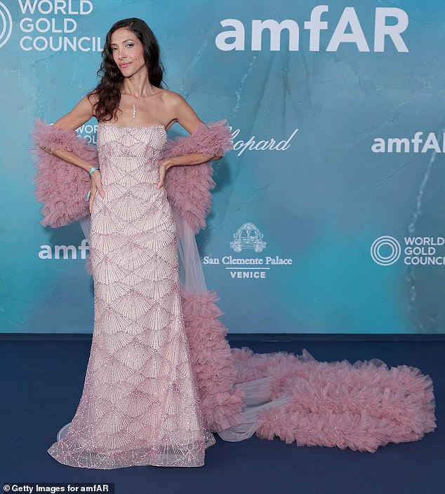 Model Claudia Carpentier wore a sequinned gown with long ruffled train