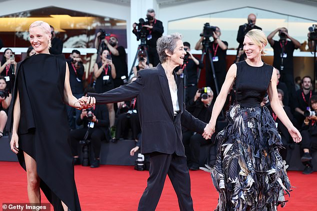 The glamorous trio showed their close bond extended off screen as they laughed and held hands together on the red carpet