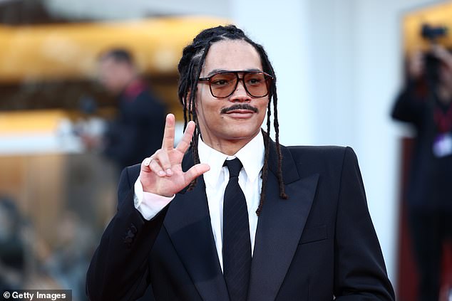The Grown-ish actor completed his look with a collared shirt and black tie, while sporting orange tinted shades