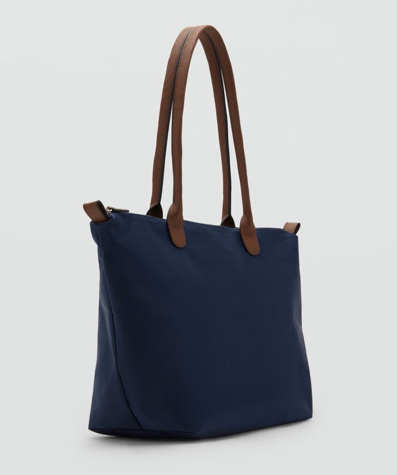 Navy blue tote bag with brown leather handles.