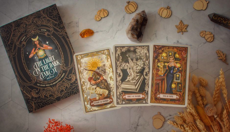 Tarot cards and guidebook spread on a table.