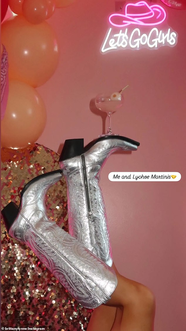 One photo showed Brittany balancing a lychee martini on her metallic silver cowboy boot
