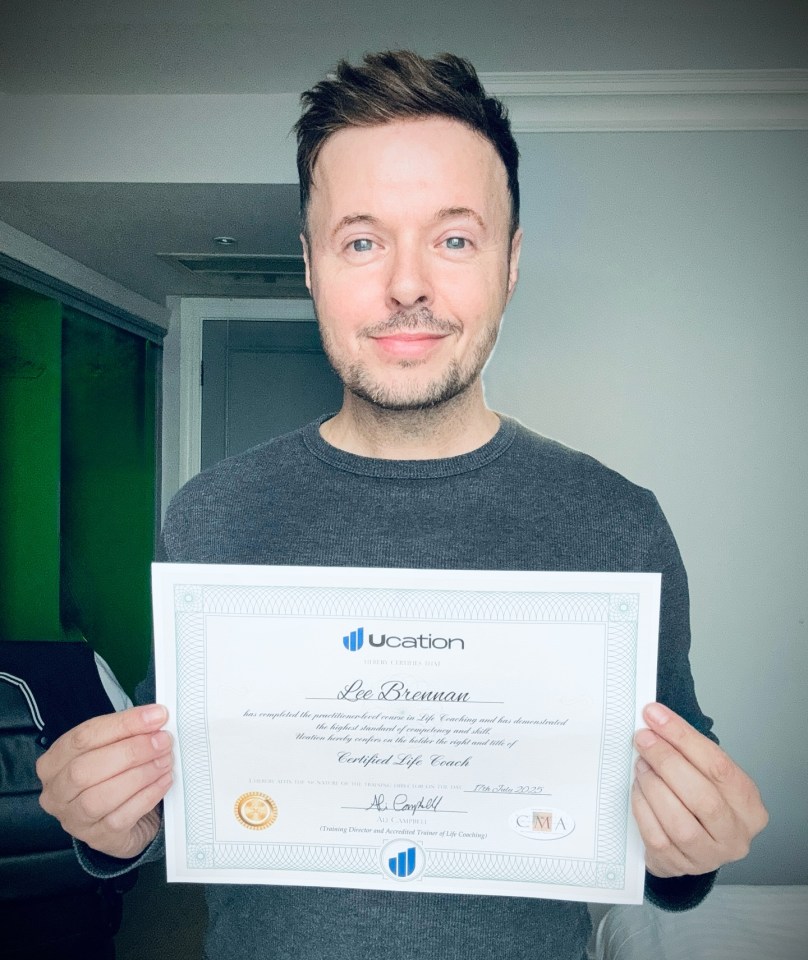 Lee Brennan holding his Certified Life Coach certificate.