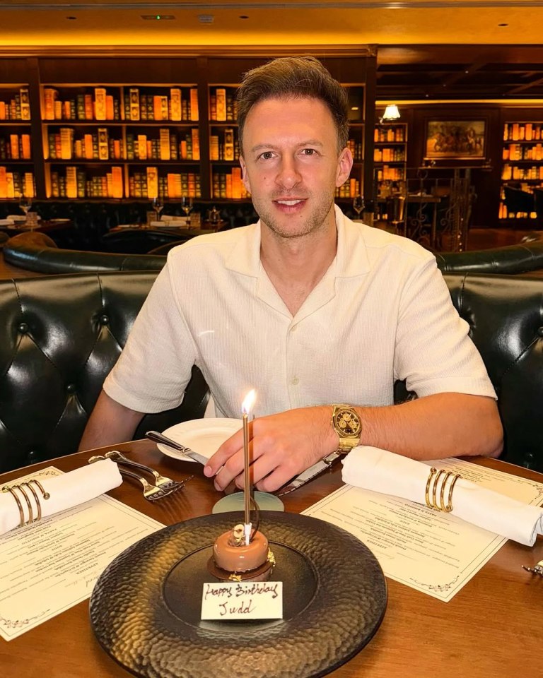 Judd Trump celebrating his birthday with a small cake.