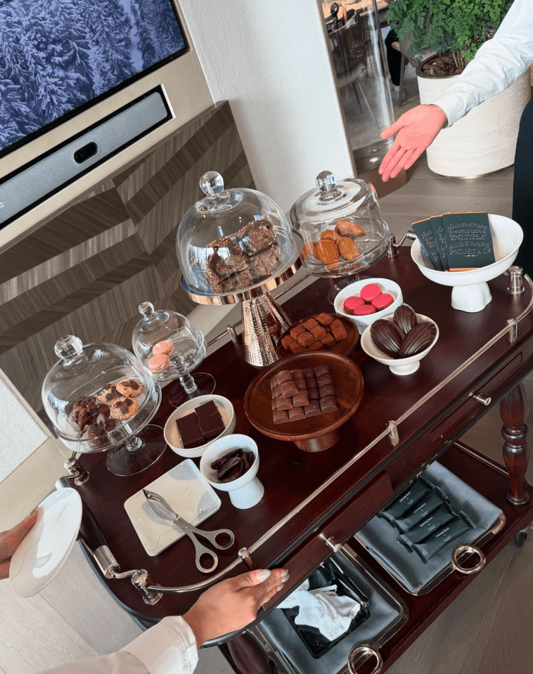 Assorted pastries and chocolates on a serving cart.