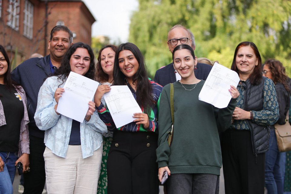 a group of people holding up papers that say ' a ' on them