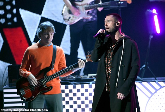 Musician Mickey Madden (left), a one-time bassist for the popular band Maroon 5 opposite Adam Levine, is accused of physically attacking his wife after she confronted him about sending inappropriate text messages to teenagers. Pictured in LA in 2018