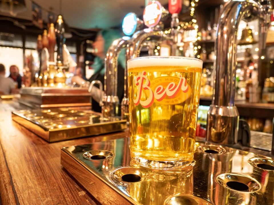 Pint of lager on a pub bar.