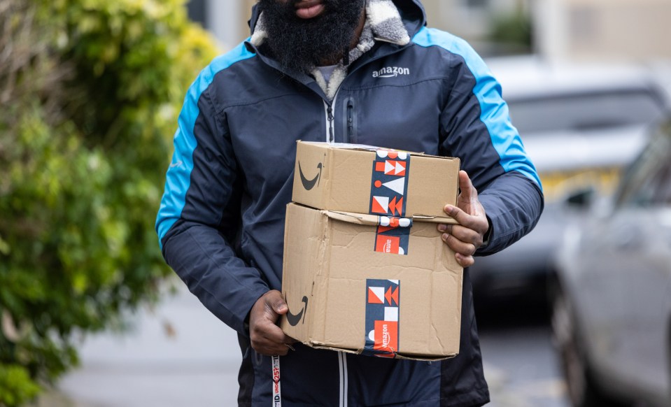 Amazon delivery person carrying packages.