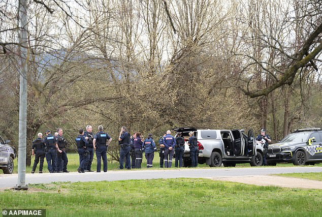 Police near the scene where two police officers were killed and another was wounded at a property near Porepunkah, 300km northeast of Melbourne