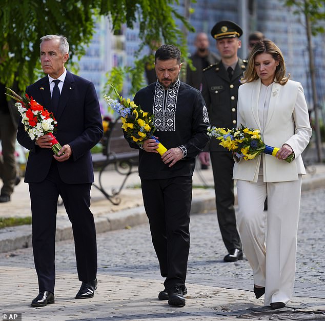 Canada's prime minister Mark Carney joins Ukrainian president Volodymyr Zelensky and his wife, Olena Zelenska, as they take part in a wreath laying ceremony in Kyiv on Sunday