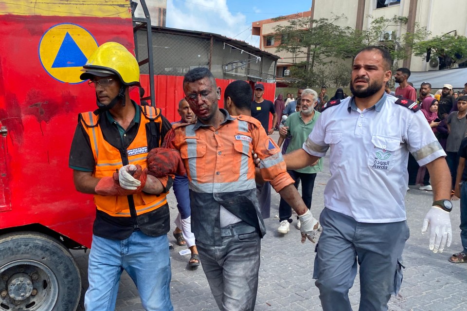 Injured man being helped by medics after Israeli strikes in Gaza.