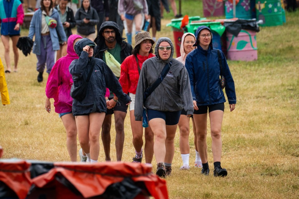 Festival attendees walking in the rain.