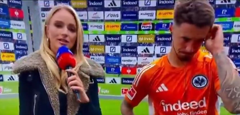 A reporter interviews a distraught soccer player after a 4-1 loss.