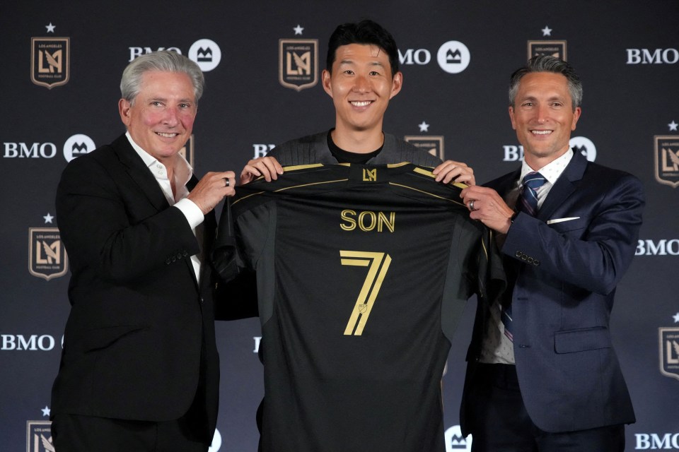 Son Heung-min at LAFC press conference, holding his new jersey with team owners.