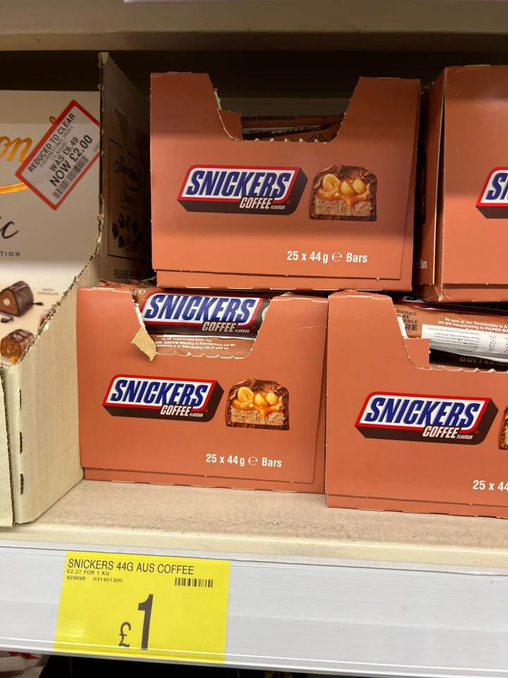 Boxes of Snickers Coffee flavored candy bars on a store shelf.