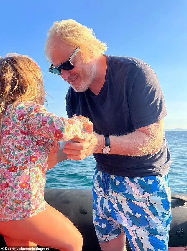 Boris Johnson holds his three-year-old daughter Romy during their family holiday to Greece