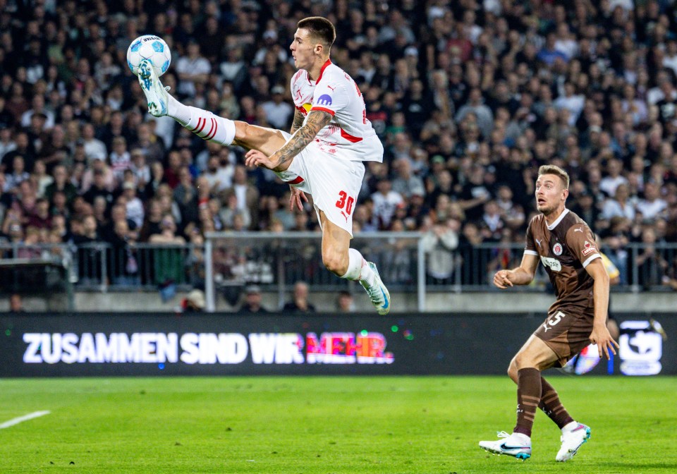 Soccer players vying for the ball during a Bundesliga match.