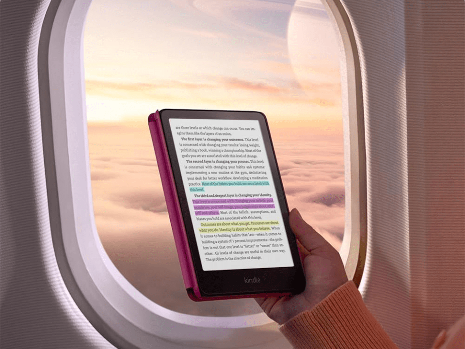 Person reading e-reader on airplane.