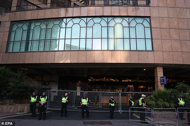 Police officers guard the Britannia Hotel housing asylum seekers during a demonstration