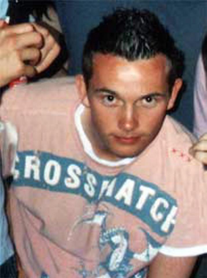 Close-up photo of a young man with spiky hair wearing a pink shirt with a blue design.