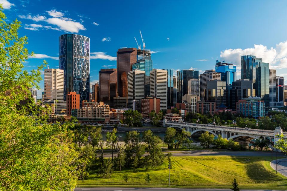 Calgary skyline with a bridge and river.