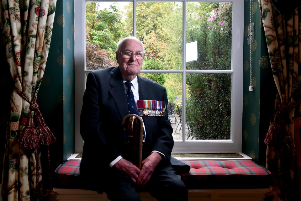 Portrait of a 100-year-old World War II fighter pilot, wearing his medals.