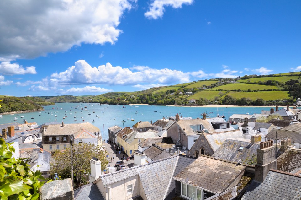 View of Salcombe, Devon, showing boats in the estuary and rooftops of the town.
