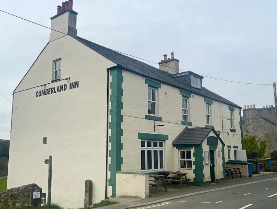 Cumberland Inn, a cream-colored pub with dark green trim.