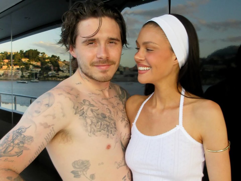 Nicola Peltz and Brooklyn Beckham embracing.