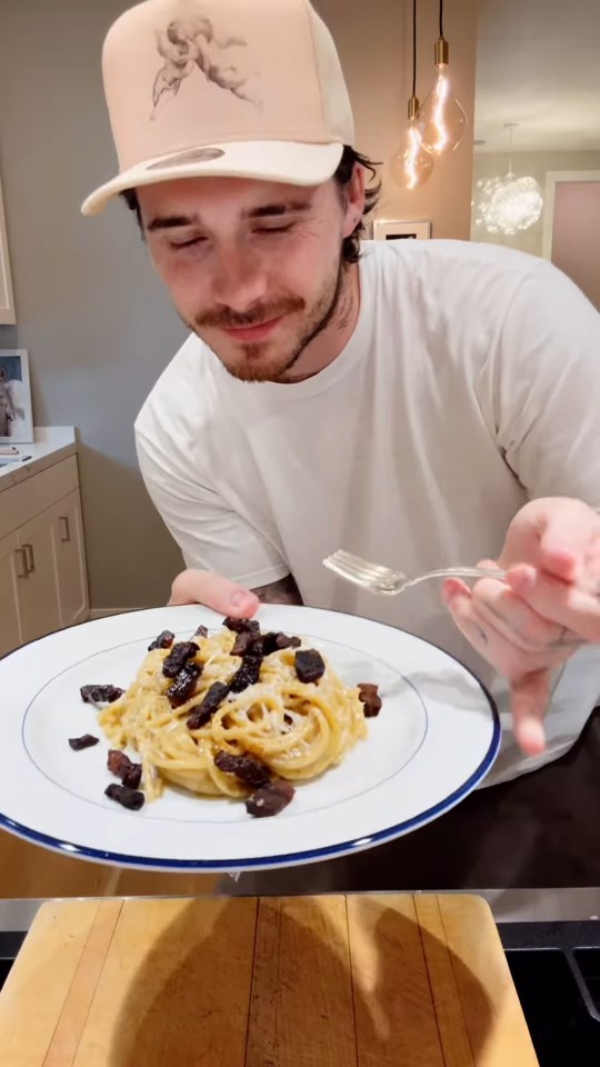 Brooklyn Beckham presenting a plate of pasta.