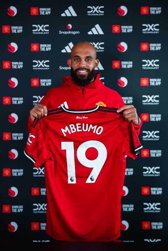 Bryan Mbeumo holding up his new Manchester United jersey.