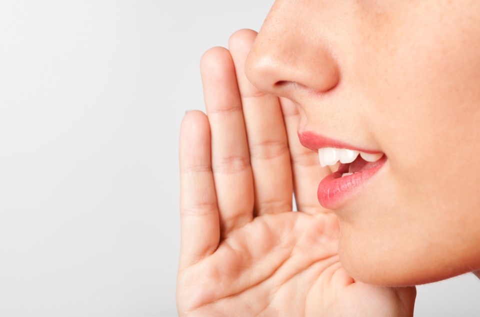 Woman whispering a secret.