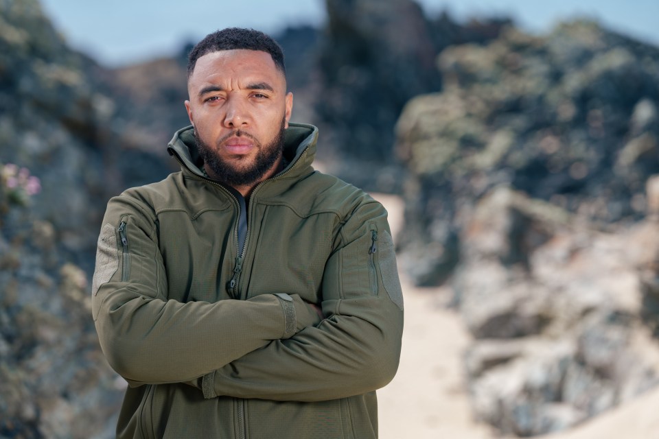 Troy Deeney on a beach, arms crossed.
